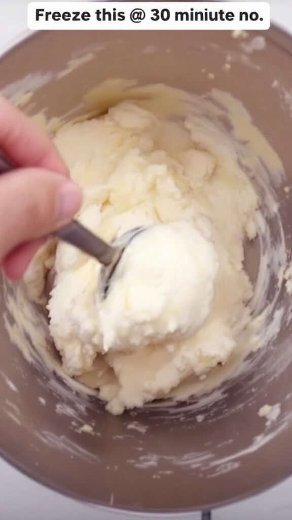 Protein Ice Cream Recipe: Creamy, High-Protein Frozen Treat 7 Spoon stirring semi-frozen ice cream mixture in container showcasing texture at the 30-minute freezing mark