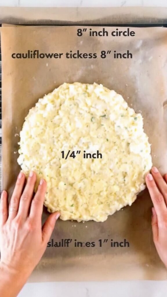 Crispy Cauliflower Pizza Crust (Keto &Amp; Gluten-Free) 7 Hands forming a circle of cauliflower mixture on parchment paper, with a ruler showing its 8-inch diameter and ¼ inch thickness