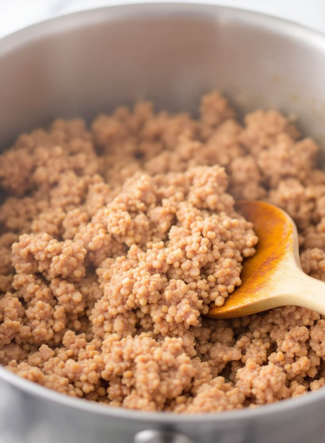 Weight Watchers Taco Soup 4 Browning ground turkey in a stainless steel dutch oven with wooden spoon