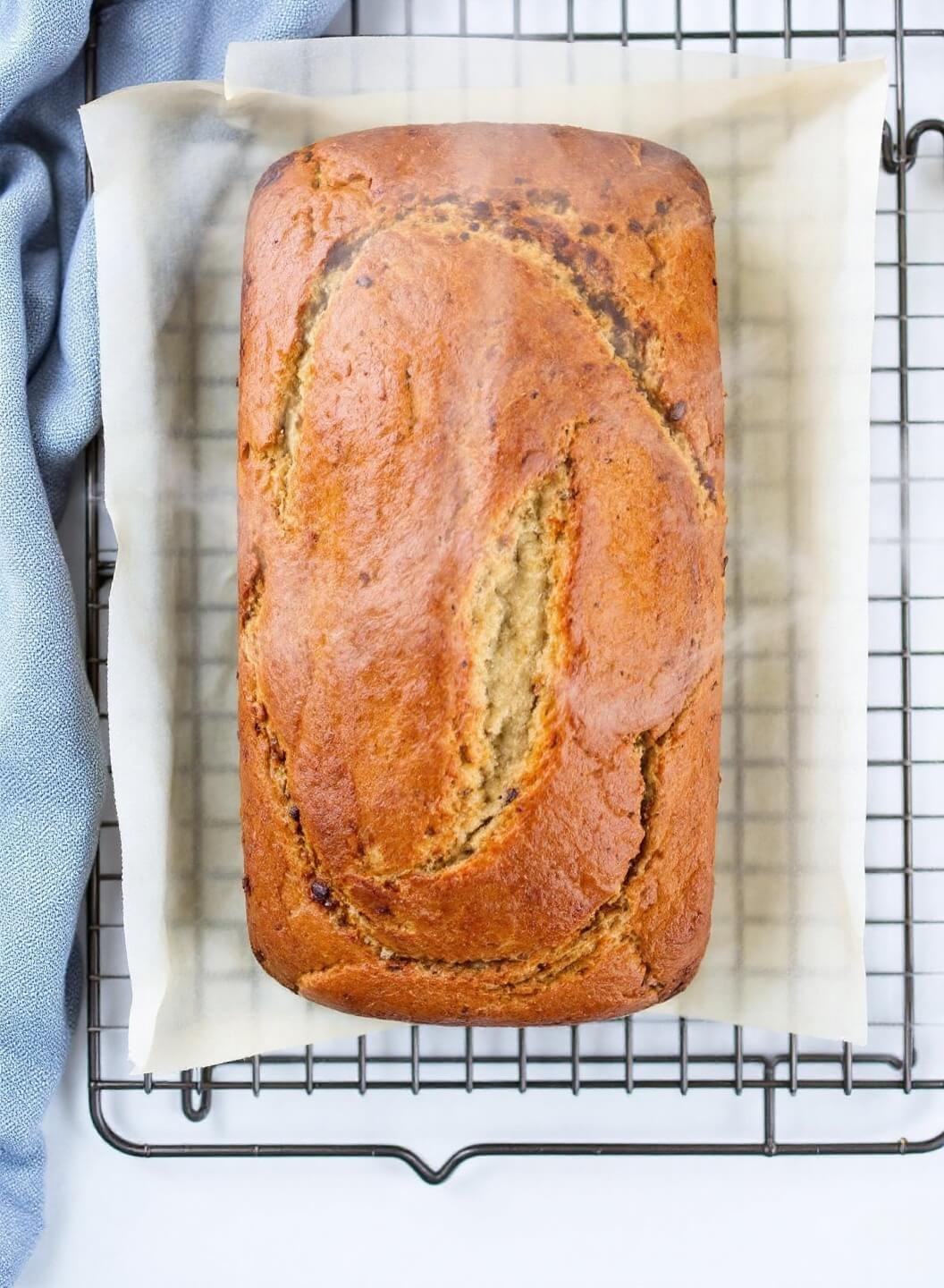 Classic Banana Bread Recipe (That Never Fails!) 7 Golden brown banana bread cooling on a rack with steam rising