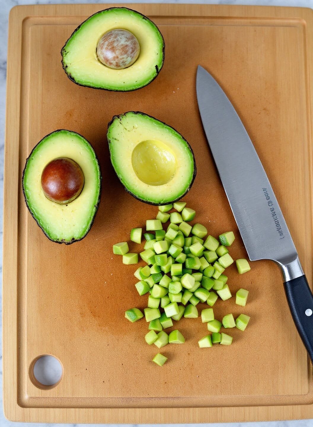 Stuffed Avocado Bowls With Turkey And Lettuce (30-Minute Low-Carb Meal) 5 Halved avocados with lime juice drizzle on a cutting board for preparation