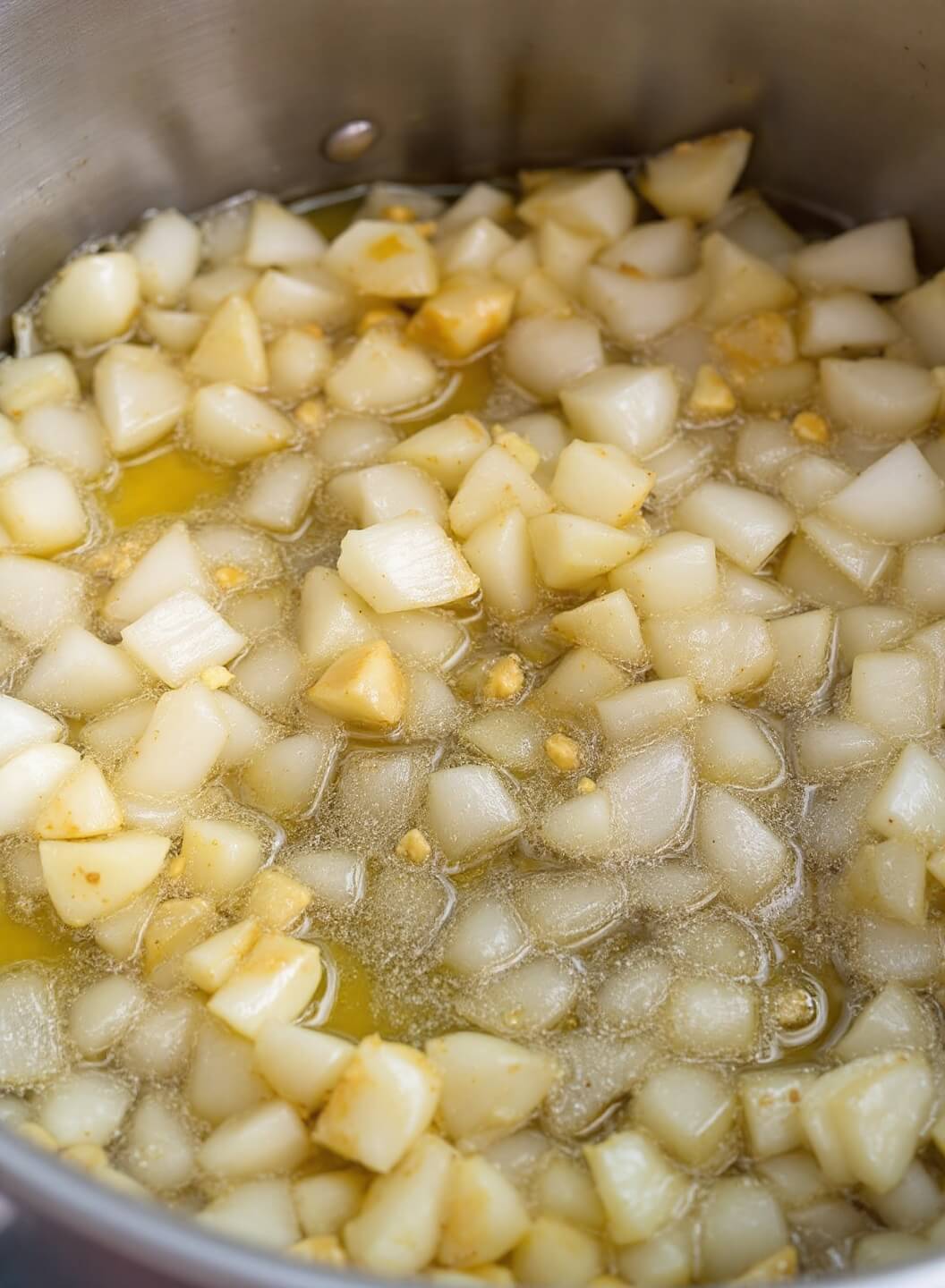 Hearty Mung Bean Soup (Vegan-Friendly) 4 Sautéing onions, garlic, and ginger in a stainless steel pot with olive oil