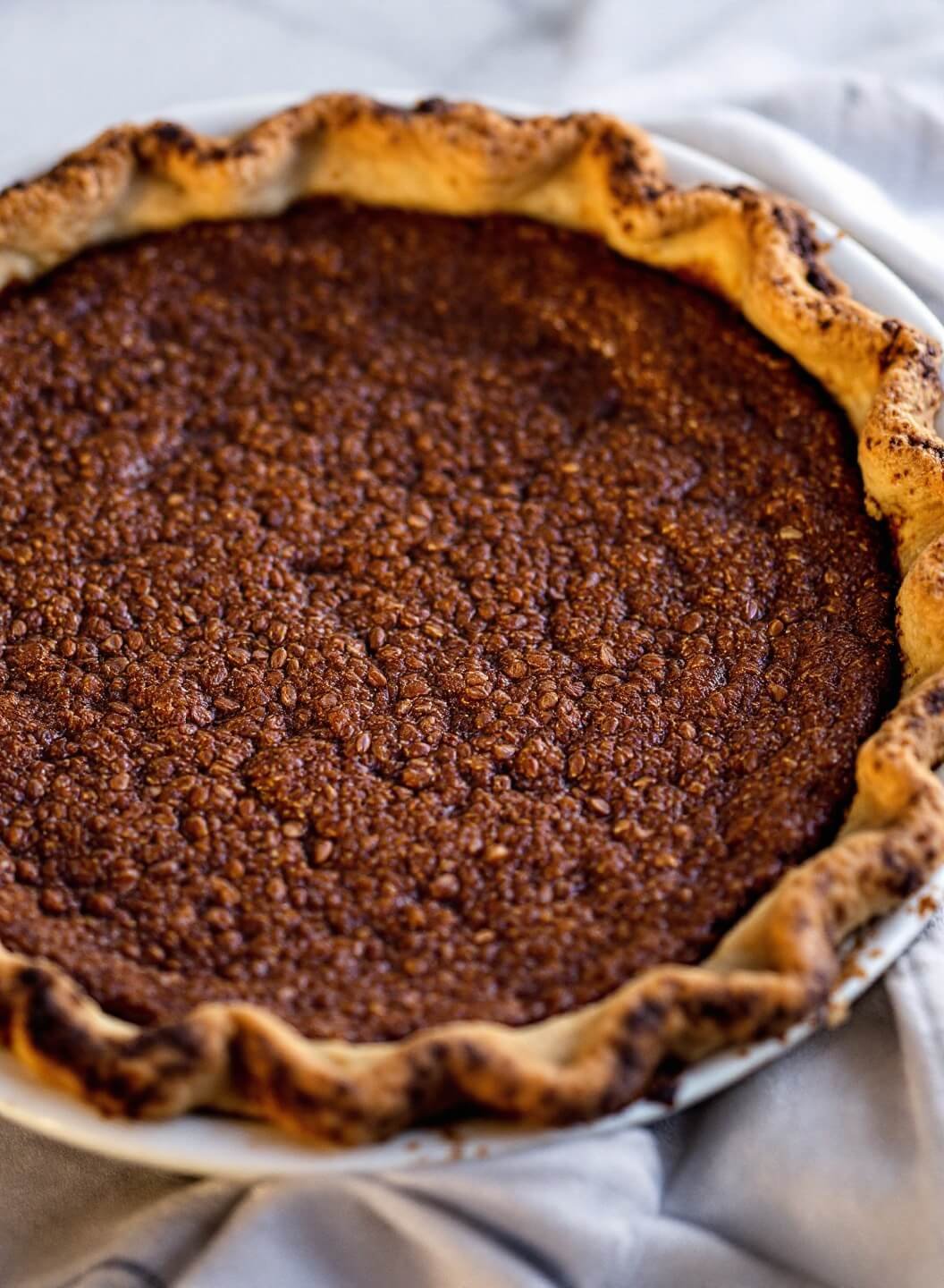 High-Protein Chocolate Mousse Pie With Almond Crust 3 Golden brown rustic almond crust pie shell under warm lighting