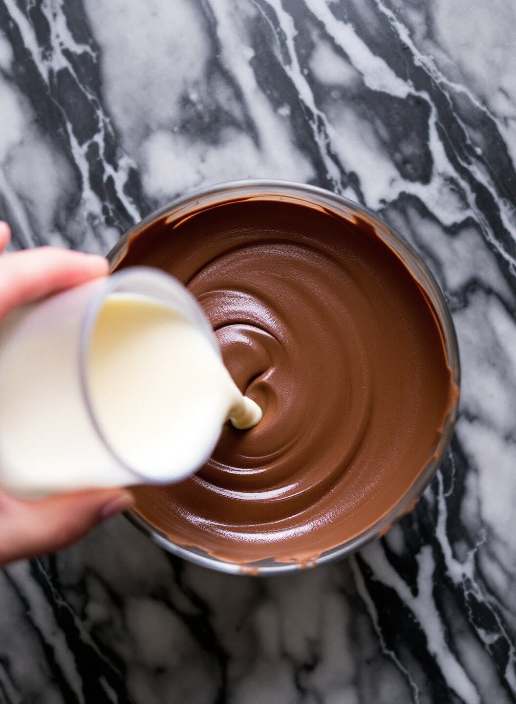 High-Protein Chocolate Mousse Pie With Almond Crust 6 Pouring chocolate mousse onto a marble surface creating smooth waves