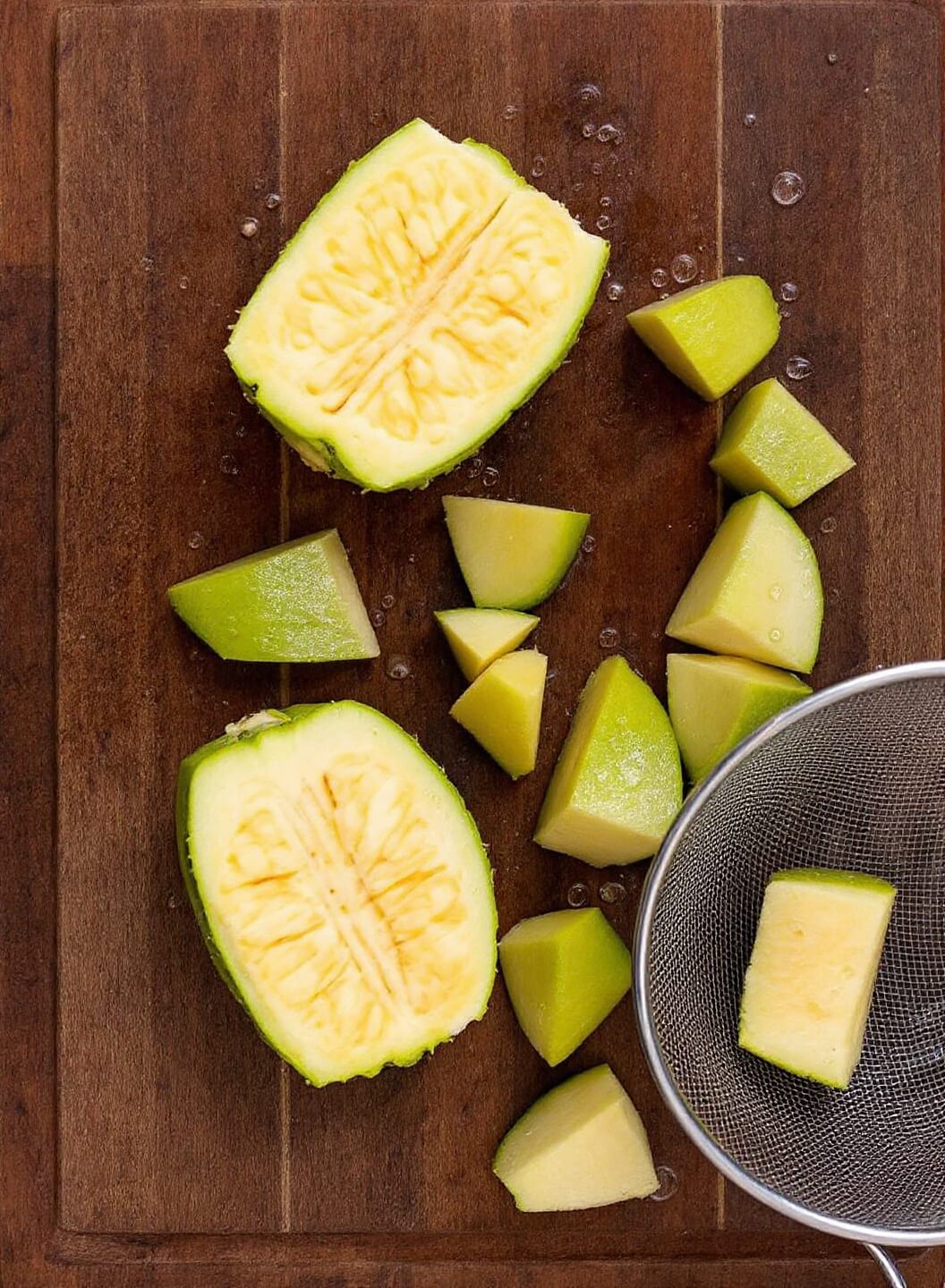 Bbq Jackfruit Pulled &Quot;Pork&Quot; (Vegan) 3 Cleaning and separating young green jackfruit pieces on a rustic wooden cutting board with a wet fine mesh strainer nearby
