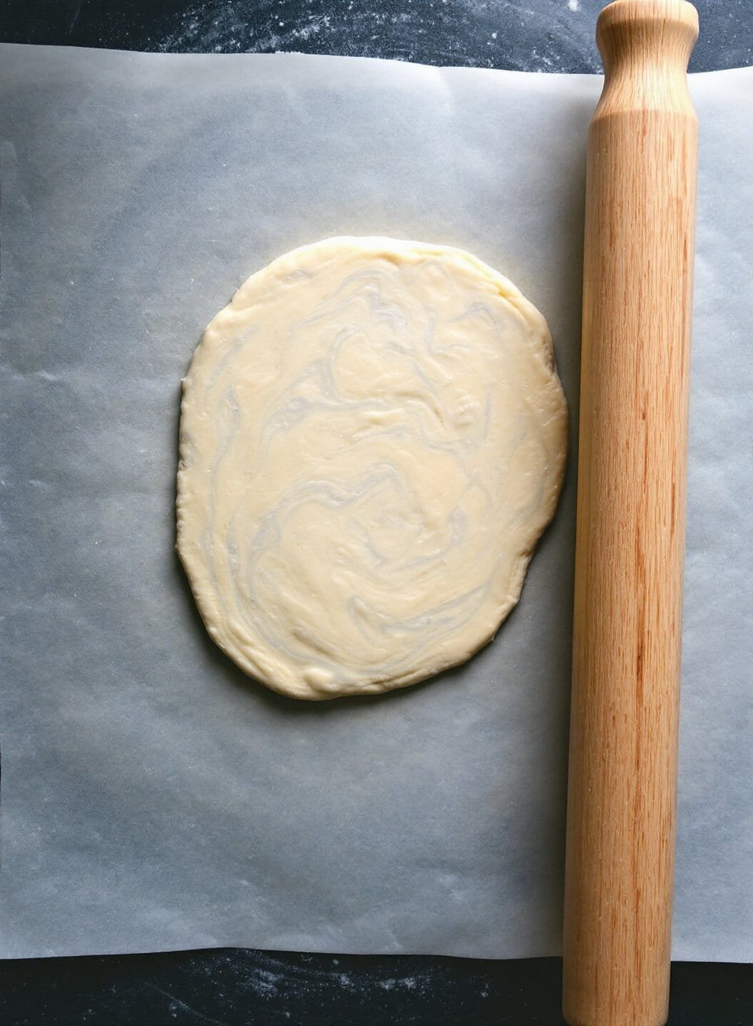 Keto Beef Wellington With Fathead Dough Crust 5 Rolling fathead dough with marbled texture between parchment papers
