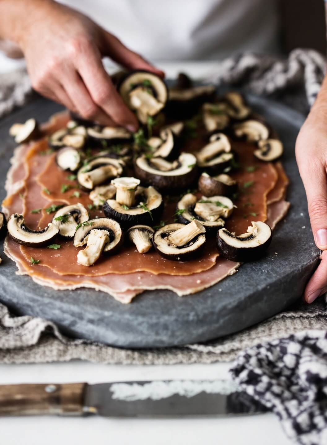 Keto Beef Wellington With Fathead Dough Crust 6 Artistic preparation of layering prosciutto and mushroom spread for wellington assembly