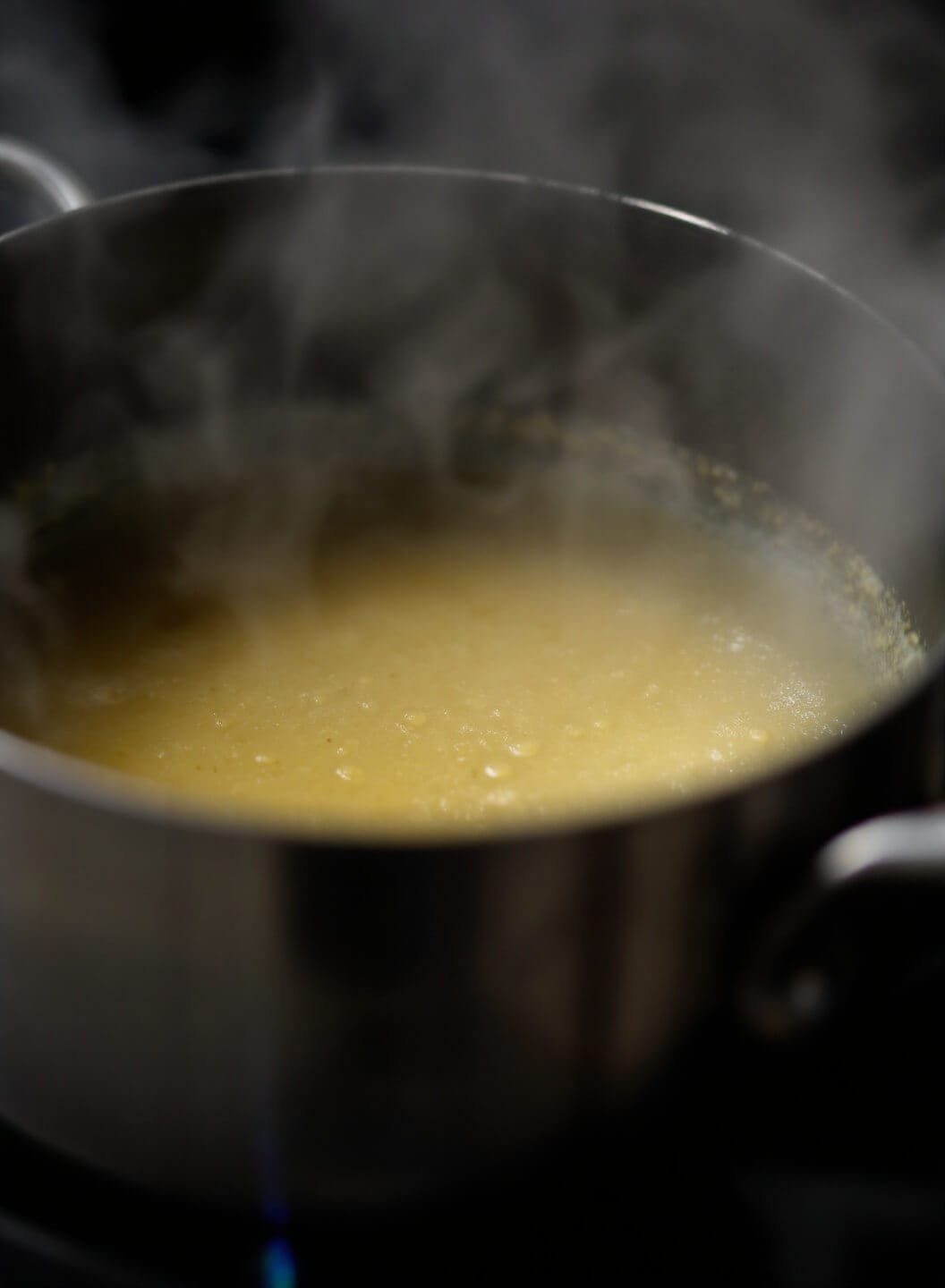 Crispy Baked Buffalo Wings (No Breading) - Restaurant-Style Results At Home 6 Butter sauce simmering in a saucepan with steam rising