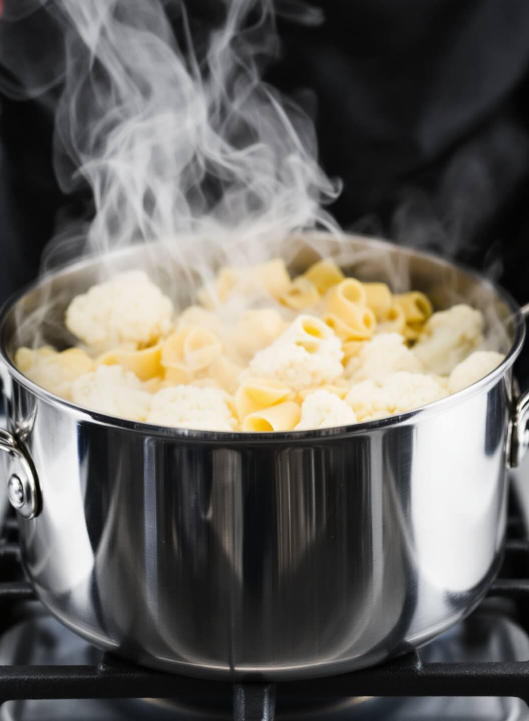 Baked Ziti With Cauliflower &Amp; Three Cheeses 4 Boiling pasta and cauliflower in a stainless steel pot with steam rising, in action shot