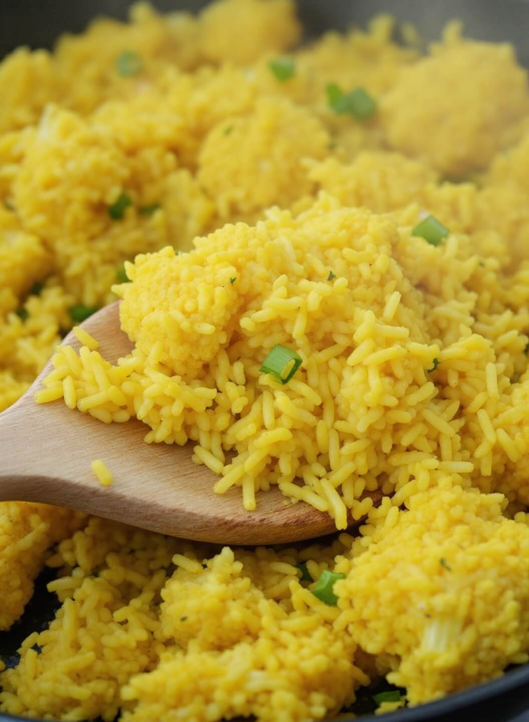 Vegan Keto Buddha Bowl - A Vibrant Low-Carb Plant-Based Feast 5 Steaming yellow turmeric cauliflower rice sizzling in a cast iron skillet