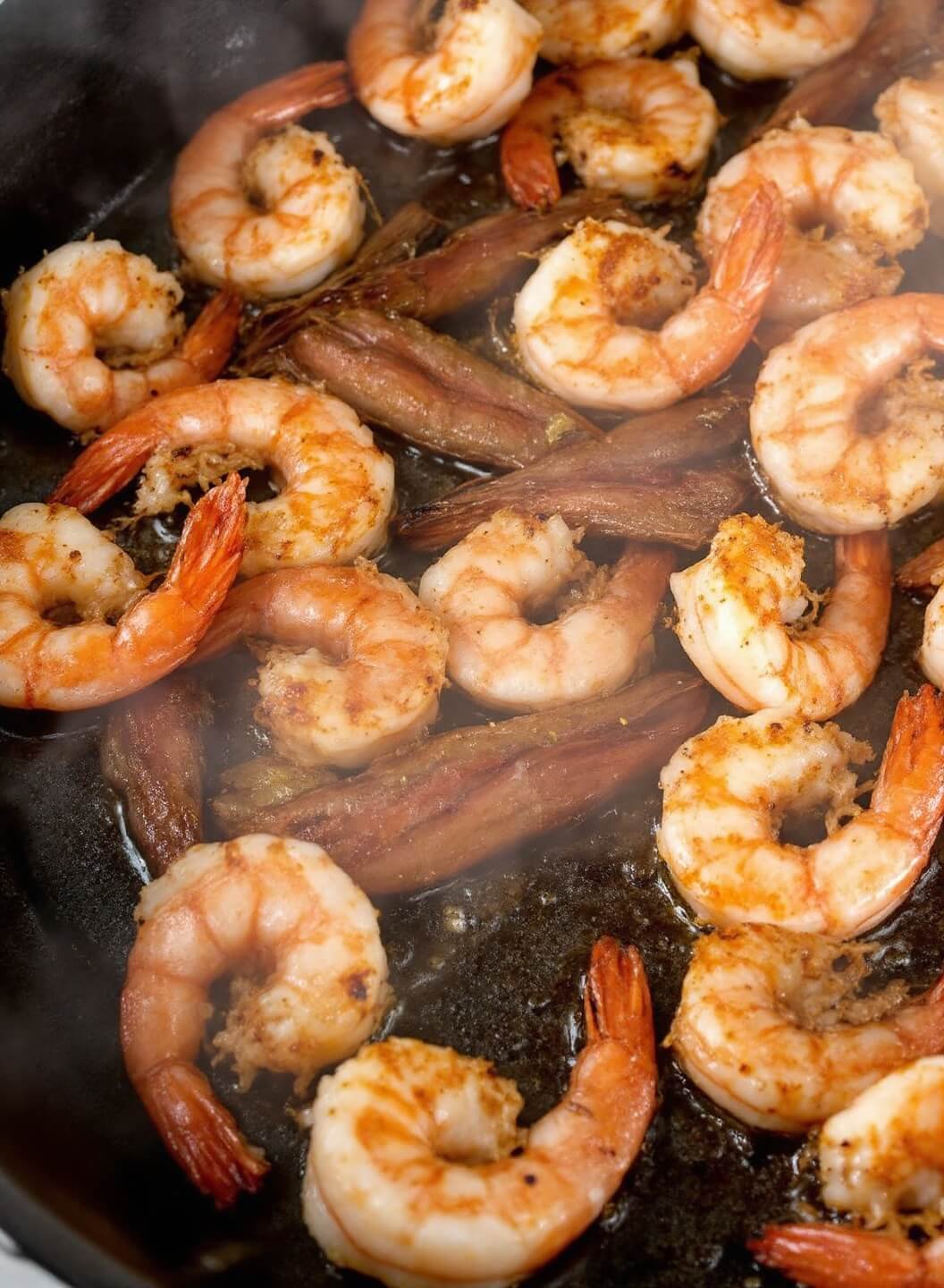 Spicy Shrimp Tacos (With Coconut Flour Tortillas Or Lettuce Wraps) 4 Sizzling shrimp being cooked in a cast iron skillet with visible steam