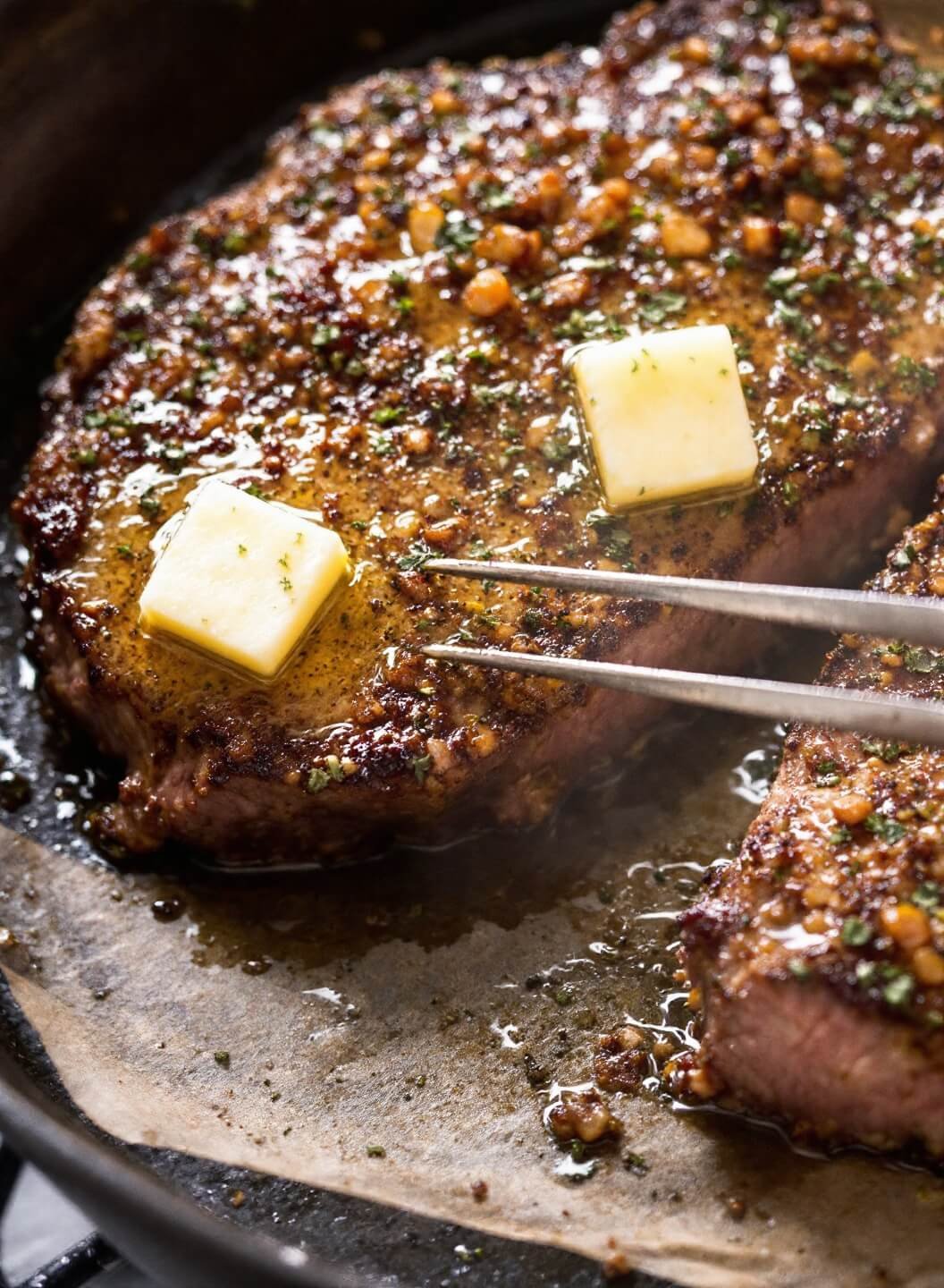 Perfect Pan-Seared Ribeye With Garlic Butter 5 Melting golden butter with herbs being basted over a crusted steak