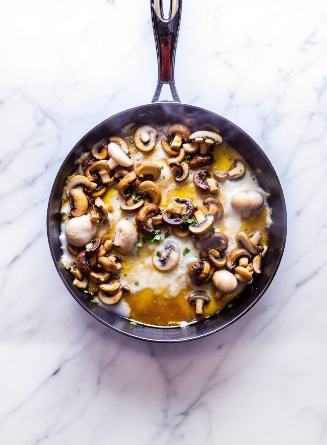 Creamy Mushroom Cauliflower Risotto 4 Sauteed golden brown mushrooms with butter foam in a cast iron pan, steam rising