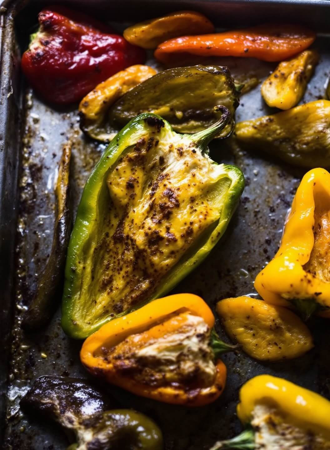 Classic Stuffed Bell Peppers With Ground Beef &Amp; Cheese 4 Roasted peppers in a baking dish under golden light