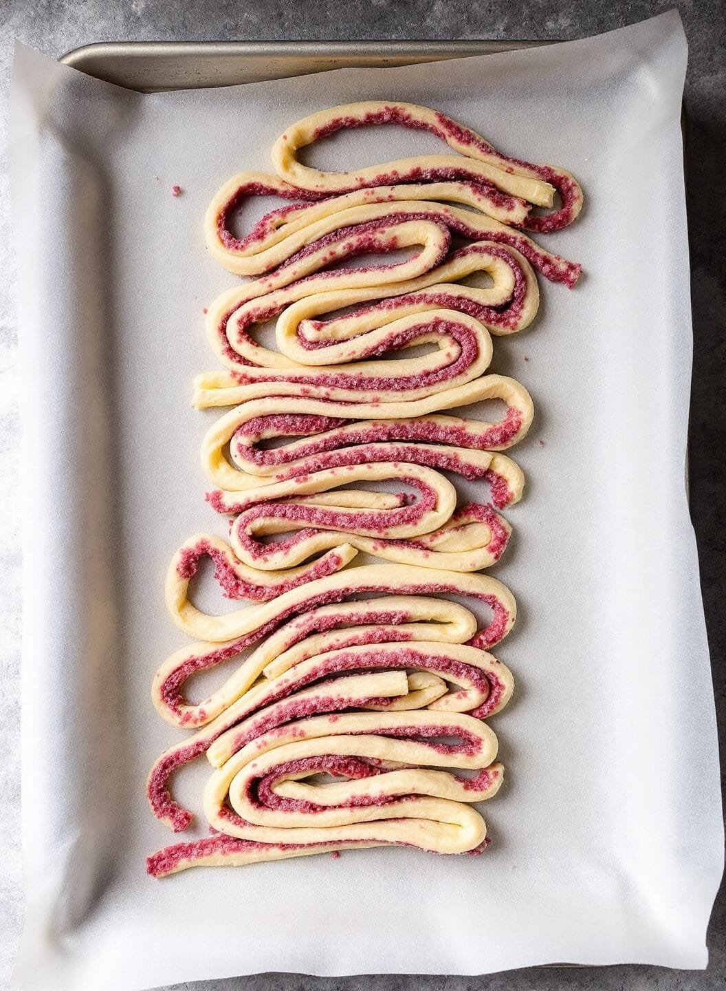 Keto Cinnamon Rolls (Fathead Dough) 6 Spiral cut raw rolls on a parchment lined baking sheet