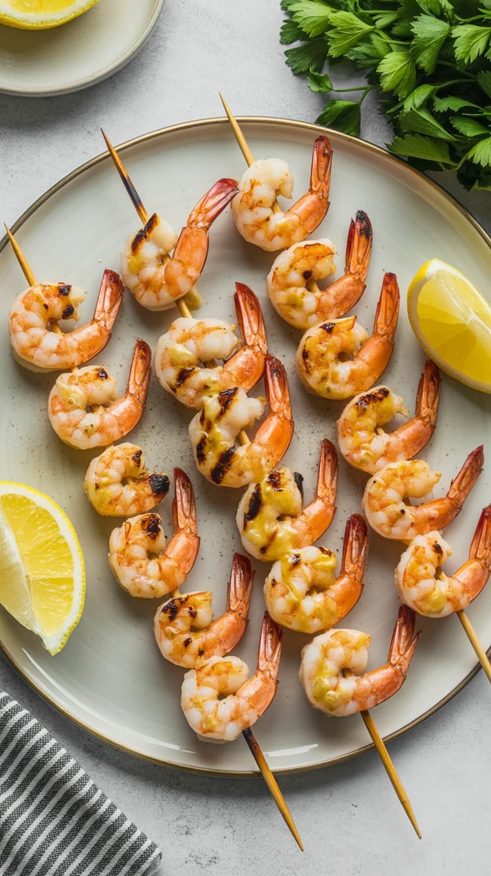 8 Delicious Keto-Friendly Seafood Recipes For Quick Meals 8 Grilled lemon-butter shrimp skewers on a plate with lemon wedges